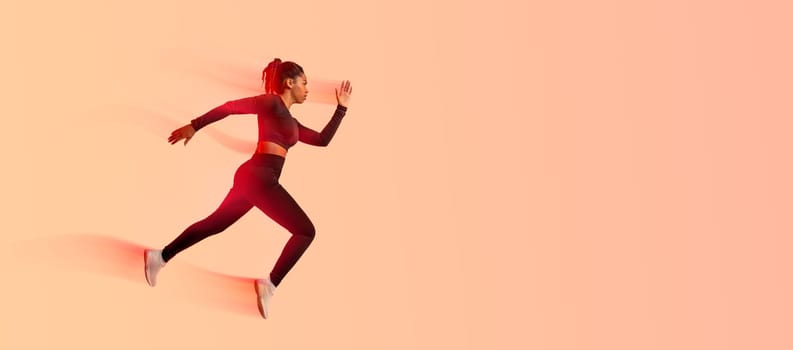 African american professional woman athlete, runner training isolated on neon colored studio background, panorama, copy space, side view. Action, motion, speed, healthy lifestyle
