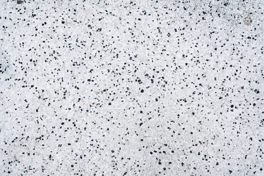 white background texture with a pattern of black stones on paving slabs