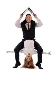 Happy businesswoman hanging upside down on neck of cheerful businessman with laptop isolated on white background