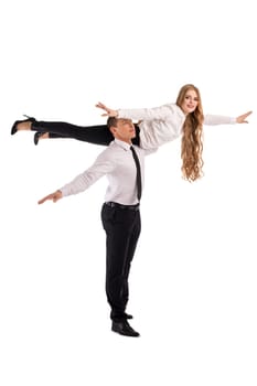 Full body side view of confident businessman carrying female partner on shoulder as concept of cooperation and trust in business