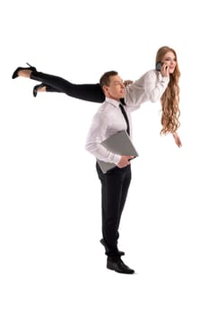 Full body side view of confident businessman carrying female partner on shoulder as concept of cooperation with notebook and cell phone