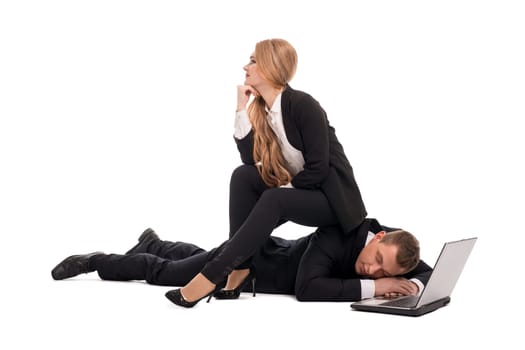 Full length of dreamy young businesswoman sitting on back of tired man sleeping near open laptop representing business and relationship concept isolated on white background