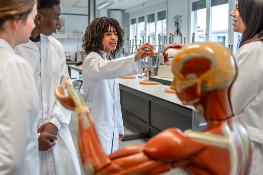 Medical students engaging in hands on learning of human anatomy with an anatomical model in a university laboratory setting
