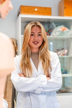 Portrait of a confident medical student standing with crossed arms in a university laboratory, showcasing her dedication to medical education