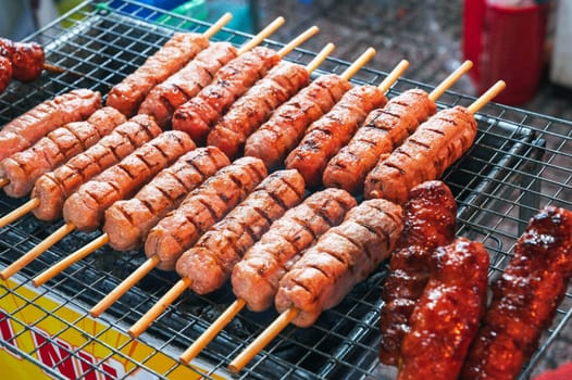 grilled sausages on sticks. Street fast food in Asia in Vietnam