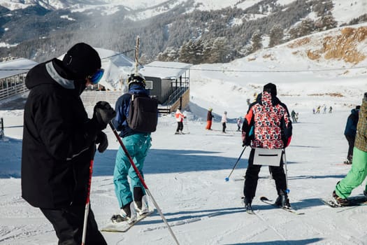 Skiers and snowboarders ride in the snow at the resort