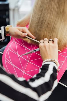 Hairstylist does a haircut styling for a woman