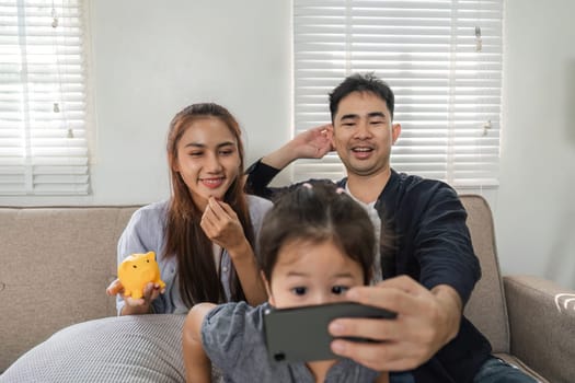A joyful family engages in a video call, capturing moments of happiness and connection in their cozy living room.