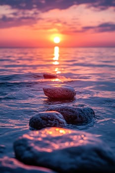 Photo of balanced stones in the sea at sunset, symbolizing harmony and balance for meditation or spa