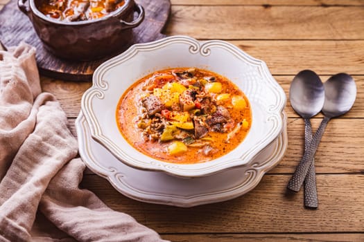 Zero waste soup, pizza soup with vegetables, mushrooms and minced meat, minestrone