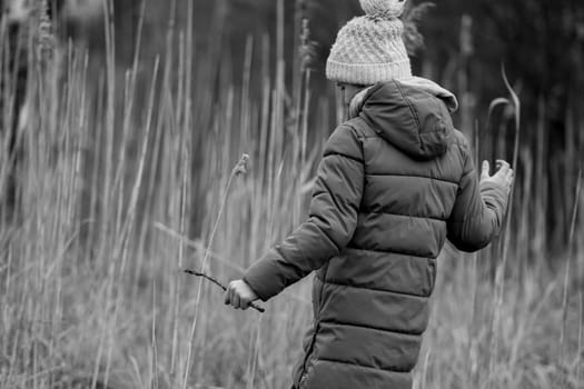Black And White Photo Of A Girl In The Forest In Early Spring Seen From Behind