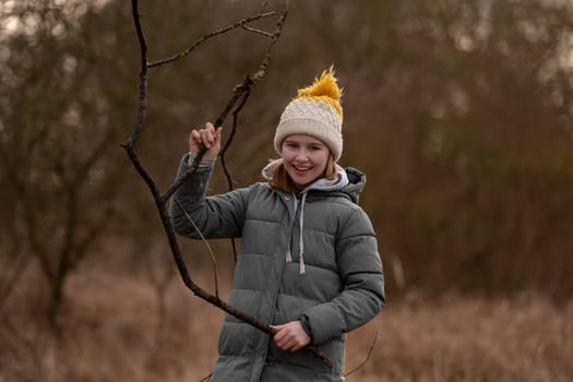 Happy Girl With A Stick In The Early Spring Forest