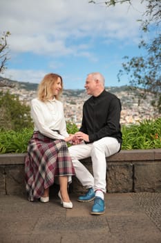 Tourists holding hands and admiring funchal cityscape in madeira island, portugal