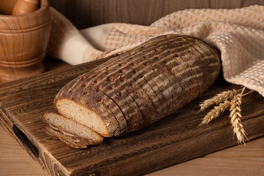 Multi grain sourdough bread with flax seeds cut on a wooden board, closeup view. Healthy vegan bread choice. High quality photo