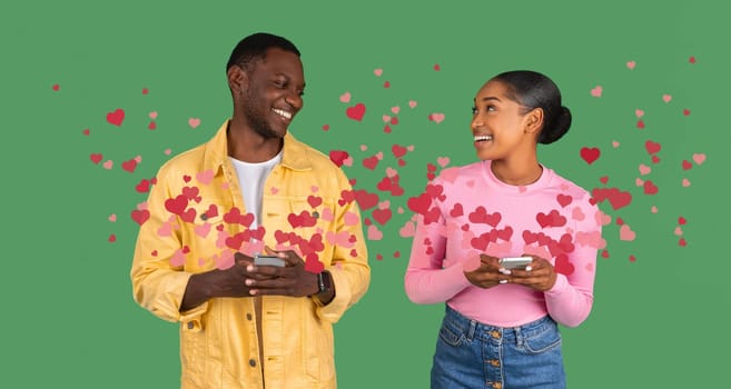 A couple shares affectionate smiles while texting each other on their smartphones. Surrounded by floating hearts, they celebrate their love on St. Valentine's Day.