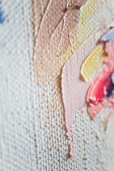 The artwork features a close-up of layered brushstrokes in various colors, reflecting texture and depth. Subtle hues blend together, revealing the artistic process behind this vibrant creation.
