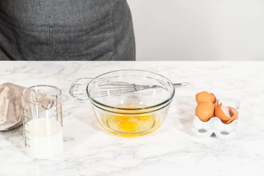 In the process of creating mouthwatering chocolate cupcakes, the first step involves meticulously mixing the ingredients in a glass mixing bowl to make the perfect batter.