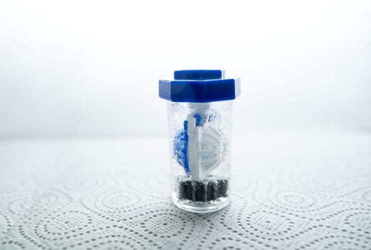 close-up of a container for cleaning and storing contact lenses for the eyes, used at home. For soft and hard lenses. in the container there is an active cleaning process, bubbles are released.