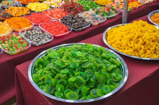 Green slices of dried kiwi. assortment of dried fruits and sweets on the oriental market