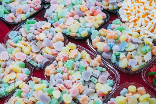 assortment of sweets marmalade and chewable candies on the counter at a candy store in the oriental market