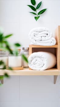 Spa treatment set, wooden shelf with neatly folded towels and dispensers for soap, cream, massage oil. High quality photo