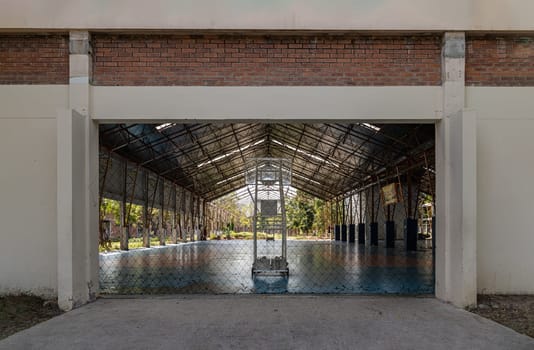 Bangkok, Thailand - Feb 19, 2025 - Basketball backboard with the hoop metal ring inside indoor basketball court at city park. use it as your Space for text, Design, Wallpaper and Poster, Selective focus.