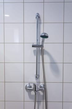 A stylish shower fixture securely mounted on beautifully tiled bathroom walls, perfect for modern interior designs