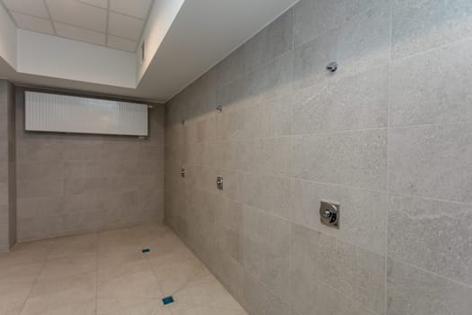 A minimalist, empty room with textured walls and utility fixtures, perfect for diverse design concepts