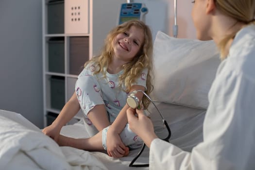 A young girl happily interacts with a friendly doctor in a welcoming hospital environment focused on care