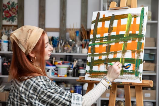 A highly talented artist skillfully captures vibrant and lively colors on canvas within a cozy art studio atmosphere