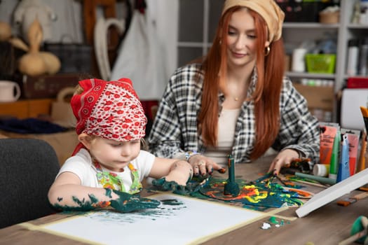 A mother and her child joyfully creating colorful art together, boosting creativity and bonding time
