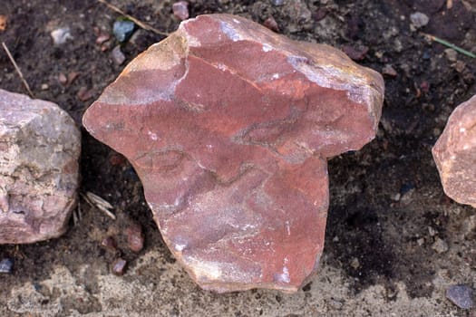 Pink sandstone stone on the dark ground. close-up