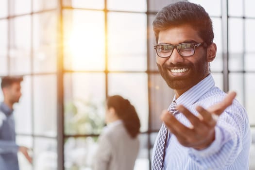 male investor beard looking at camera and smiling in modern office