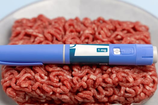 Ozempic Insulin injection pen and raw minced meat for diabetics and weight loss. High quality photo