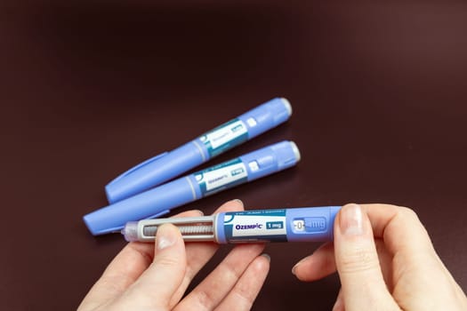 Ozempic Insulin injection pen on a dark background for diabetics and weight loss. Copenhagen, Denmark - February 16, 2025