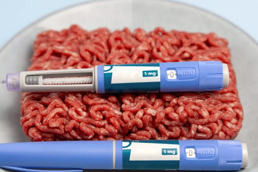 Ozempic Insulin injection pen and raw minced meat for diabetics and weight loss. High quality photo