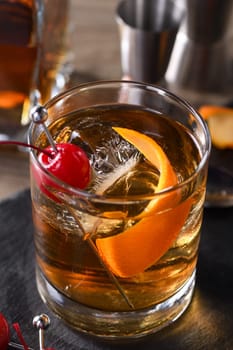 Cocktail Old Fashioned is an old-fashioned sophistication of whiskey and sweet syrup. Served with ice, orange zest and Maraschino cherry. 