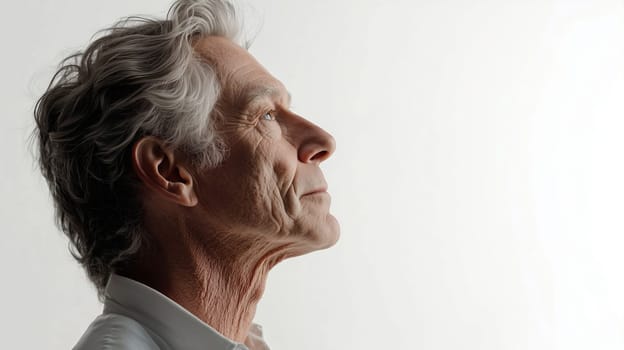 Close-up portrait of elderly man with wrinkles, old skin, profile, looking away, gray hair, side view, on white background