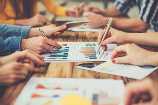 A dynamic business meeting scene where recruiters and participants collaborate on reports. Hands on tables indicate discussion and teamwork over charts and strategies.