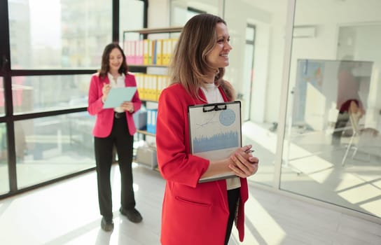 Two office workers sorting and arranging important documents.