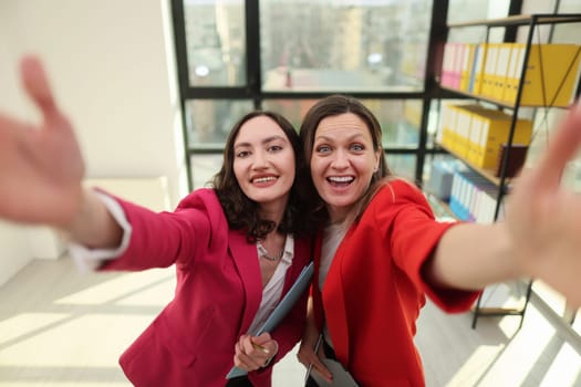 Confident business leaders posing in a modern corporate environment.