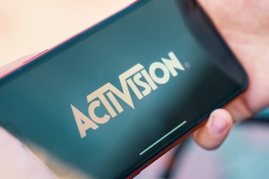 Bishkek, Kyrgyzstan - October 4, 2019: Man holding smartphone with logo of Activision on screen.