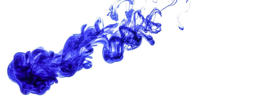 Blue ink injected into water from syringe, colour mixing with water creating abstract shapes, white background banner with space for text right side