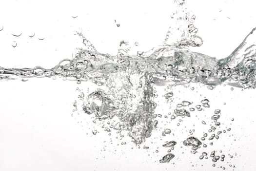 Water splashing as it's poured into tank, white background