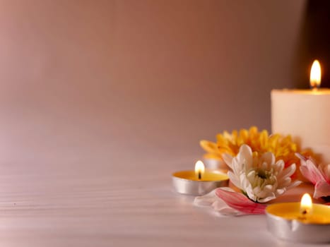 Celebration of Diwali or Deepavali holiday in India with candles and flowers in the evening at night close-up. Hindus celebrate the festival of lights on clear background, Copy Space