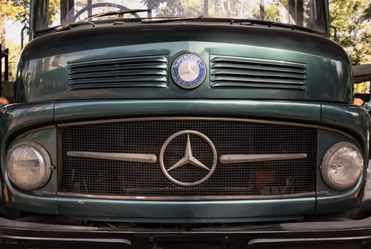 Bangkok, Thailand - Feb 19, 2025 - Front of a classical Mercedes Benz green truck in Close up. Timeless designs, use it as your Wallpaper, Poster and Space for text, Selective focus.