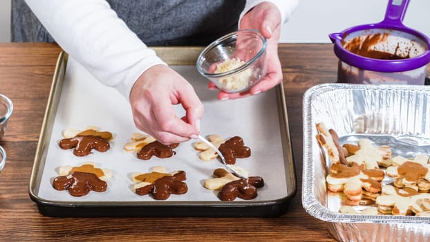 Crafting gingerbread cookie sandwiches with eggnog buttercream, presented on a rustic wooden table for Christmas gifting.