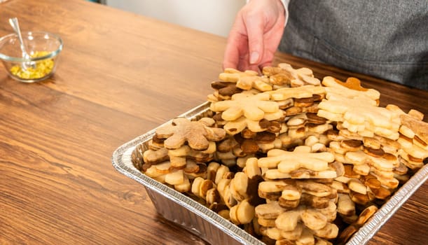 Golden-hued cookies shaped like snowflakes, intricately stacked.