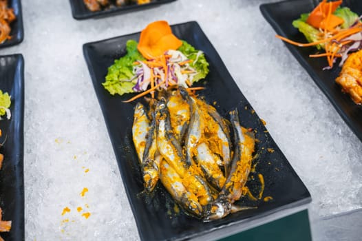 fresh seasoned spicy fish at the Asian self-service buffet in the hotel's restaurant for breakfast in Asia in Vietnam