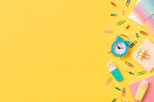 Education, back to school, e-learning, online study, distantly learning class, freelancer work concept. School supplies, stationery accessories along bottom edge on yellow background. Flat lay, top view. Copy space